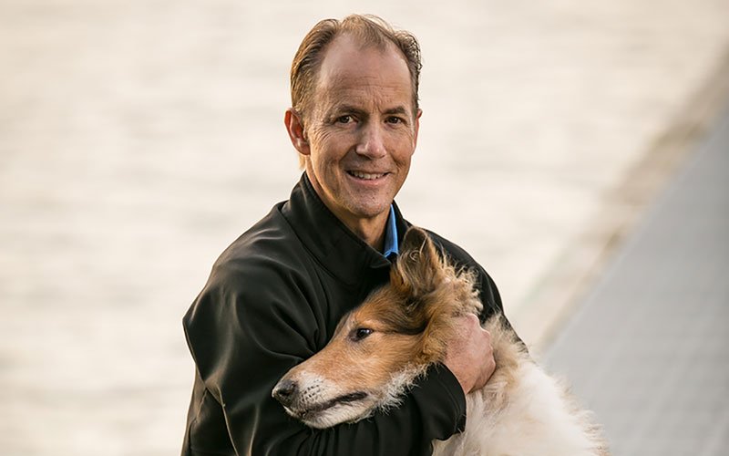 smiling man and dog on dock