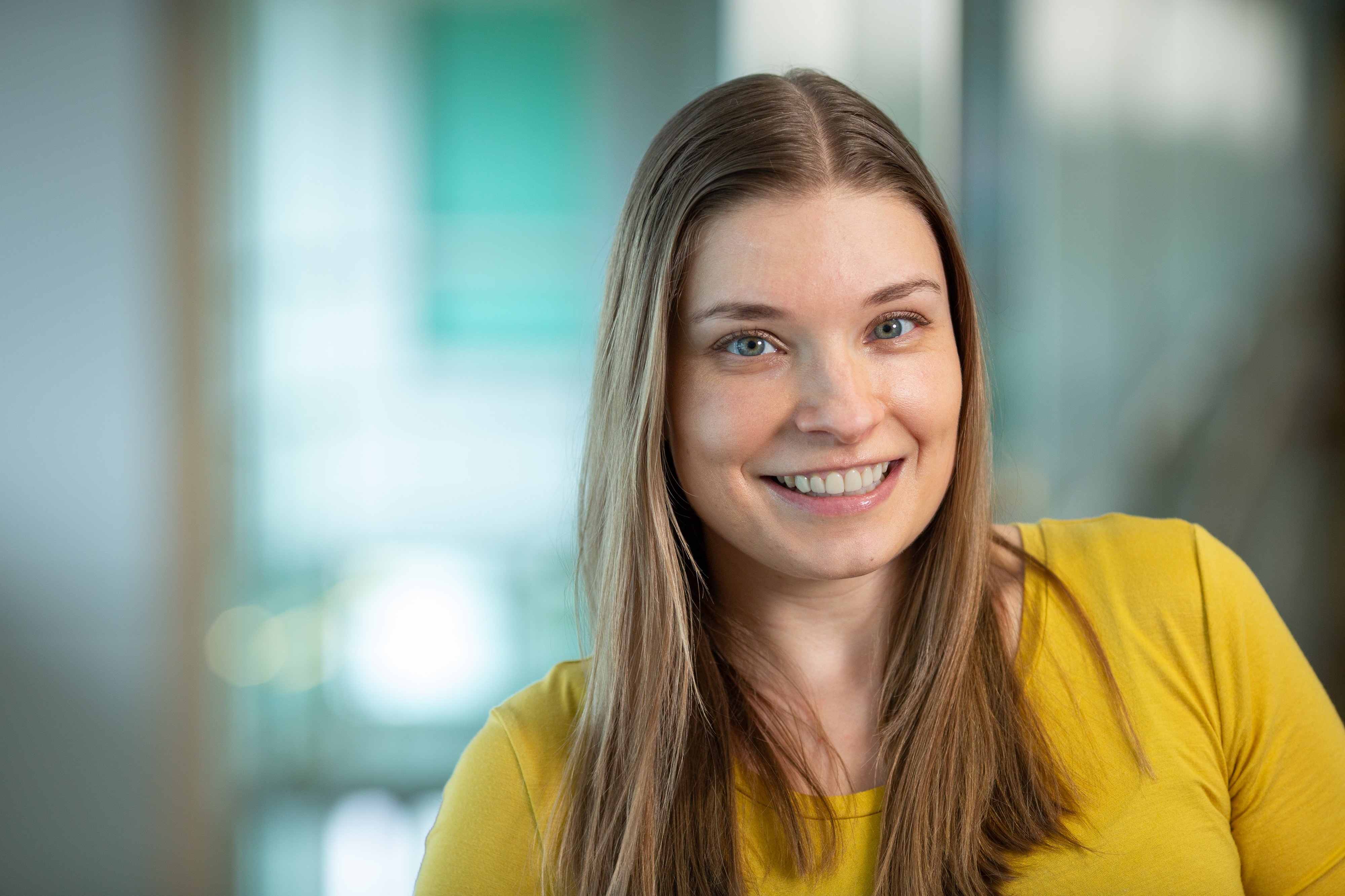 smiling woman in front of blue background