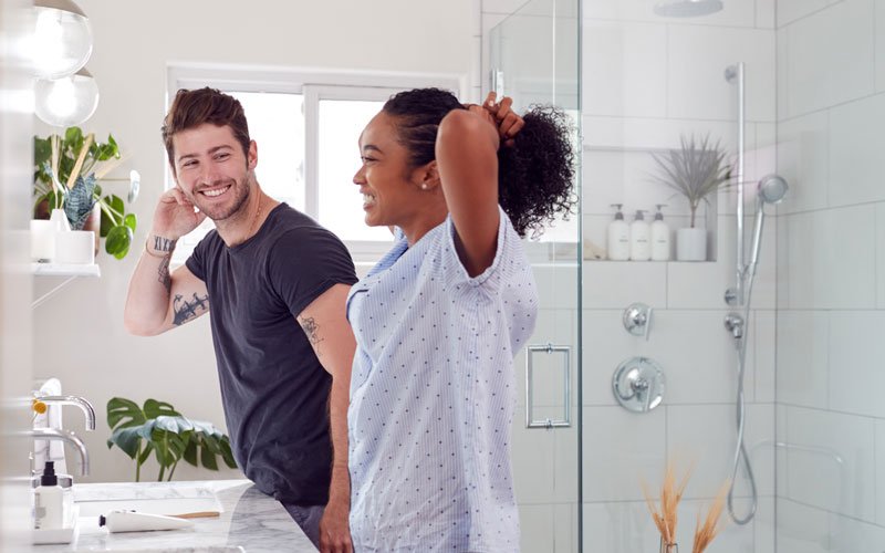 couple smiling at each other in bathroom