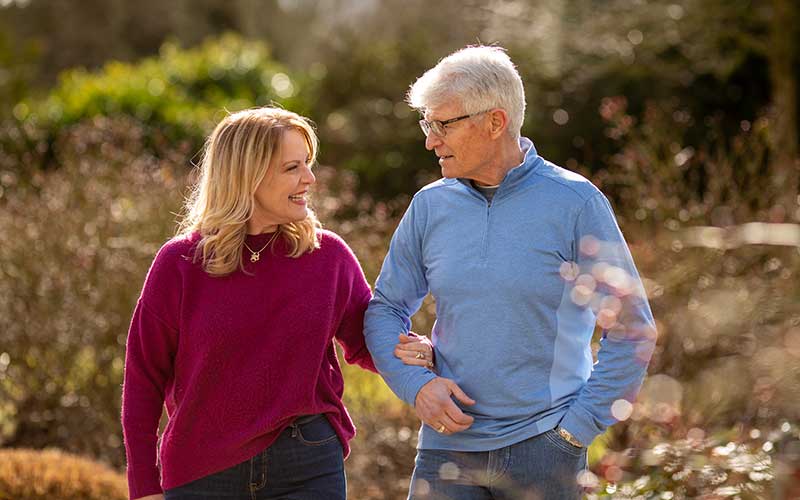 man and women walking through park